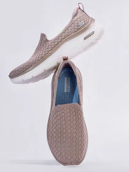 A clean and minimalist shot of Skechers Go Walk women's shoes, arranged to look as if they are floating. This technique is great for catalogue and e-commerce images, providing a clear view of the product with a touch of creative flair.
