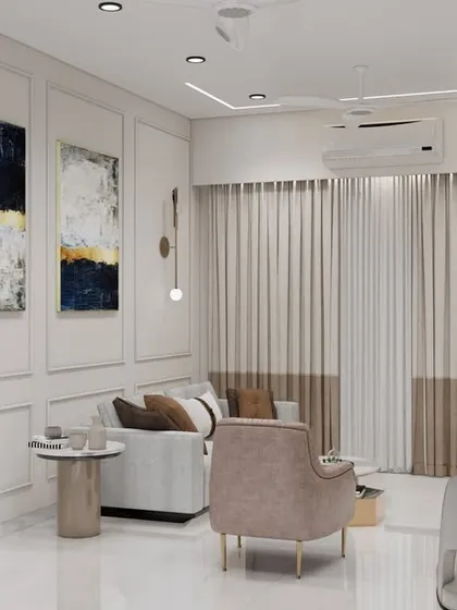 A view of the living room section, featuring wall molding for a touch of classic elegance, modern art, and contemporary pendant lights. The design proves that small spaces can be incredibly stylish.