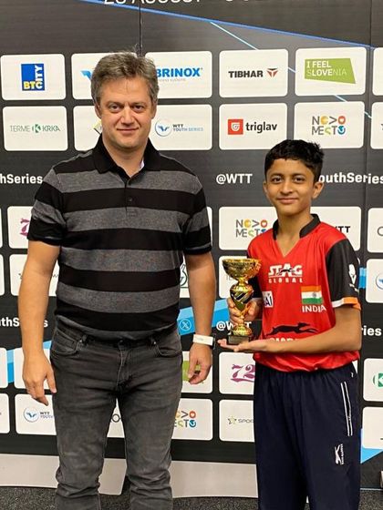 Atharva receiving his trophy at the WTT Youth Series.