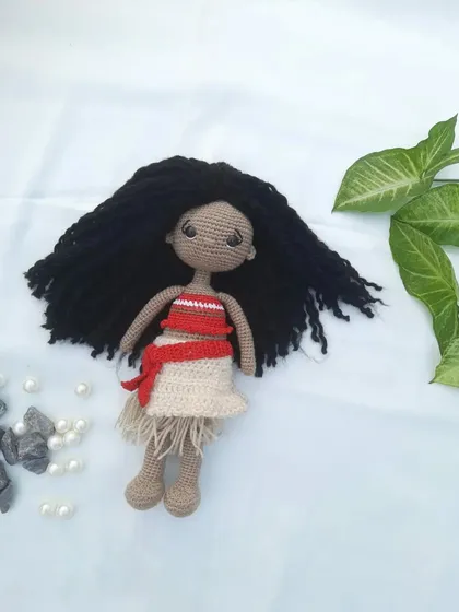 Another look at the Moana doll, showing the texture of her hair and the details of her crocheted clothing.