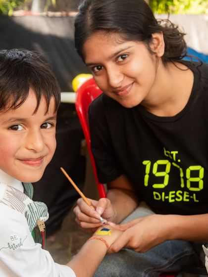 Capturing the fun activities at a birthday party. This little guest is getting his hand painted, and his happy expression says it all.