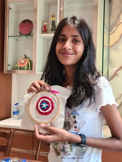 This young girl's Captain America shield is a fantastic example of how you can bring your favorite characters to life with punch needle.