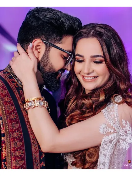An intimate and happy portrait of the couple, their smiles and close embrace telling a story of love and excitement for their future together.