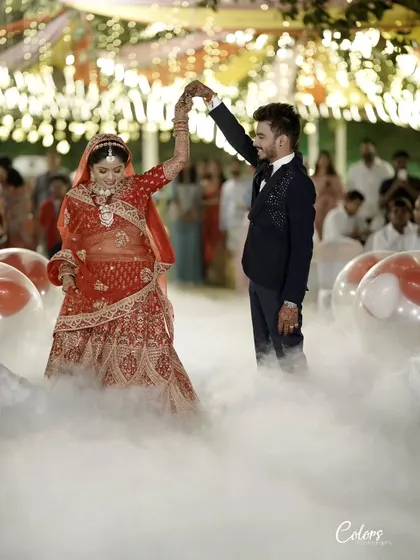 The couple shares their first dance as husband and wife, surrounded by fog and balloons for a dreamy effect.
