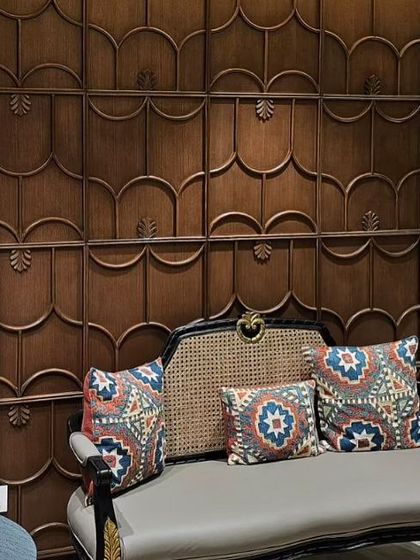 We used custom furniture from our own DCA Workshop to add a unique, boutique-like charm to KR Sons. This bench, set against a carved wooden wall panel, provides a comfortable waiting spot and showcases our commitment to bespoke craftsmanship.
