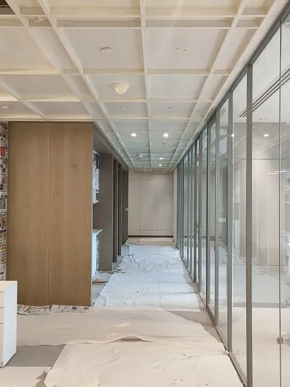 A corridor at the Hamdard HQ during construction. This behind-the-scenes view shows the coffered ceiling and wall panelling being installed, revealing the layers of craftsmanship that go into our interiors.
