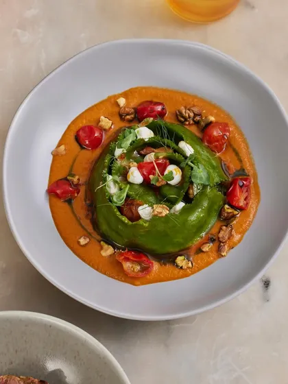 An overhead view of our Spinach and Ricotta Crown Ravioli, showcasing the beautiful crown shape and the artful arrangement of garnishes.
