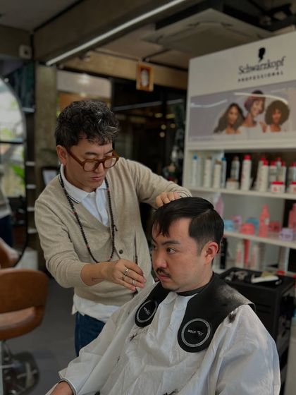 Yewong himself working on a client, showcasing his passion and expertise.
