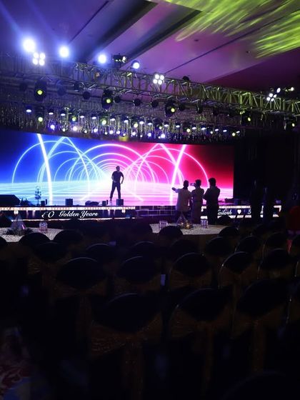 A dynamic stage setup for a corporate awards night or conference. The large LED screens and energetic lighting create a professional and high-energy atmosphere for presentations and performances.