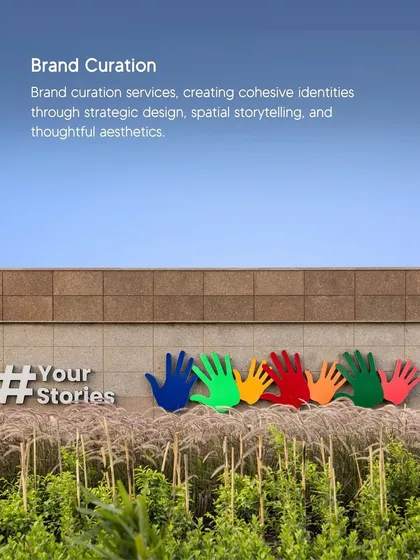 Our brand curation services create cohesive identities through strategic design and spatial storytelling. This outdoor installation, with its colorful handprints, communicates a message of community and shared stories.