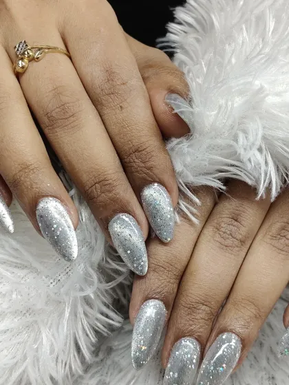 A full view of the dazzling silver glitter extensions, perfect for a party or special event where you want your nails to be the center of attention.