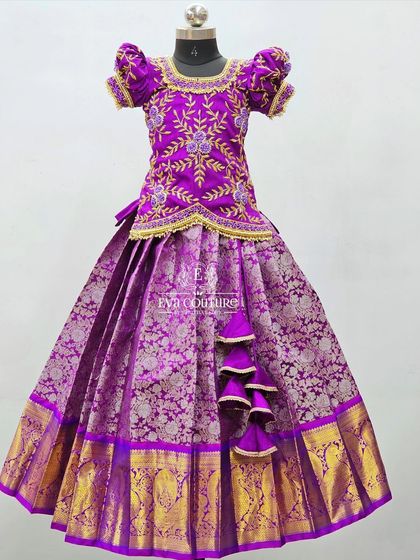 A beautiful purple Banarasi lehenga with a heavily embroidered blouse and a rich gold zari border.