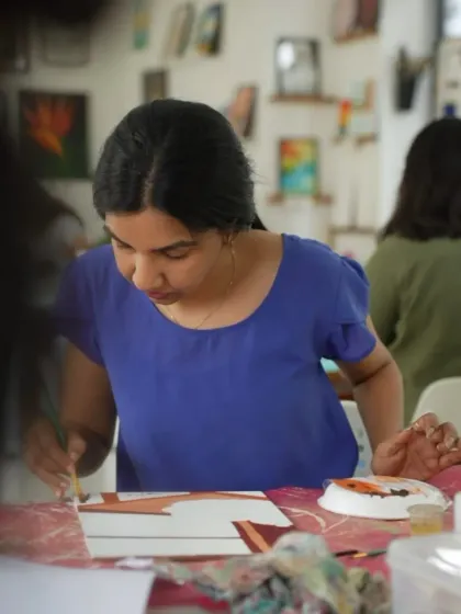 A student in our acrylics course working on her painting. The courses are designed to be beginner-friendly, with all materials and a starter kit included.
