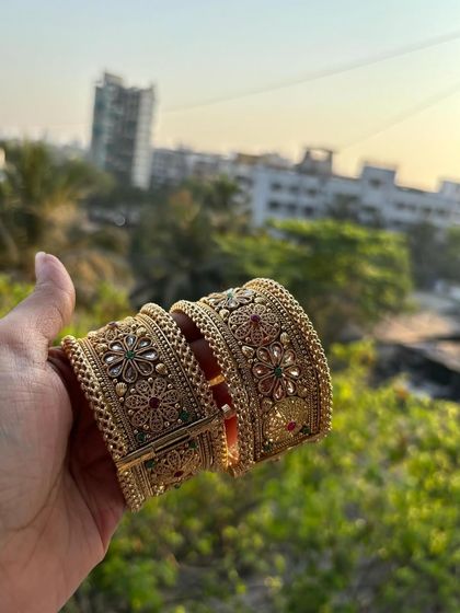 A hand-held shot of the bridal kadas, showing how they look when worn.