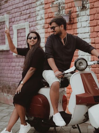 The couple having fun on a vintage scooter, a perfect prop for a quirky and memorable pre-wedding shoot.