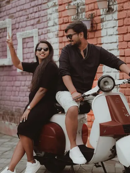 The couple having fun on a vintage scooter, a perfect prop for a quirky and memorable pre-wedding shoot.