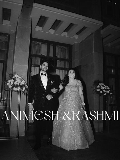 An elegant entrance. This black and white portrait of Animesh and Rashmi has a classic, cinematic feel, like a still from a glamorous old Hollywood film.