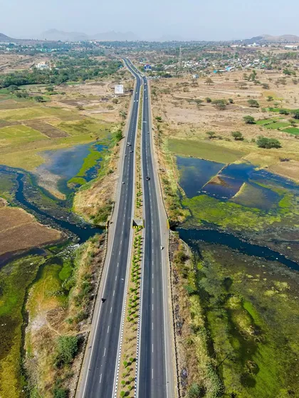 The straight line of the Mumbai-Agra Highway cuts through the rural landscape near Nashik. It's a powerful symbol of connectivity and development.