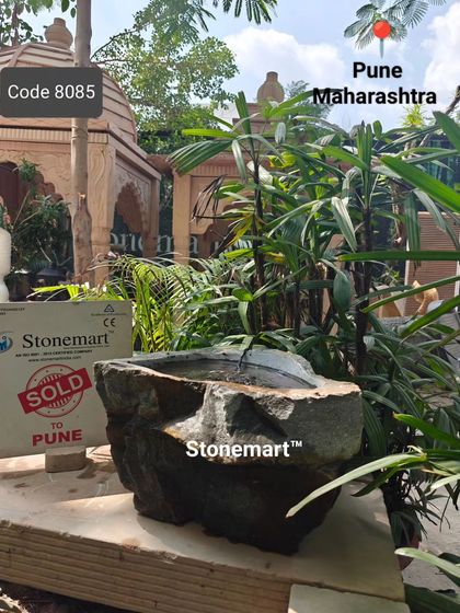 Another angle of the rock bubbler fountain, showing its unique shape and the gentle flow of water.