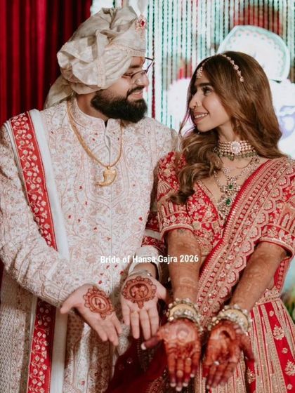 A royal couple on their wedding day. The bride and groom show off their mehendi, a beautiful symbol of their union and the traditions they share.