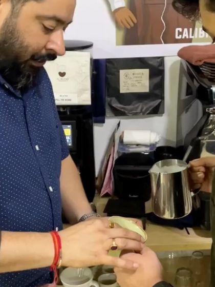 Our trainer providing one-on-one guidance on latte art pouring. We focus on building foundational skills for consistent results.