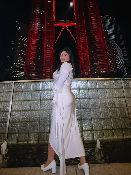 Shining bright in front of the Petronas Twin Towers in Kuala Lumpur, Malaysia, during one of my international work trips.