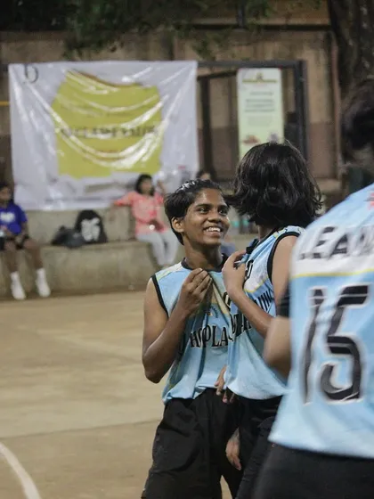 A candid moment of friendship between two players during a break in the action.