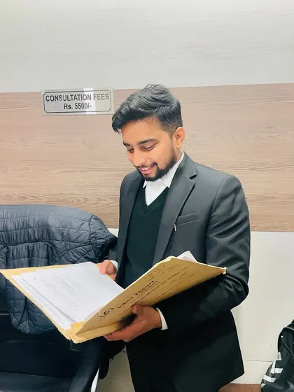 Going through a case file in my office. You can see my consultation fee sign in the background, as I believe in being transparent about all aspects of my service from the very beginning.