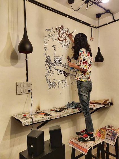Here's Bhavishya in action, working on the travel doodle. Even a small wall is a canvas for us to do something cool.