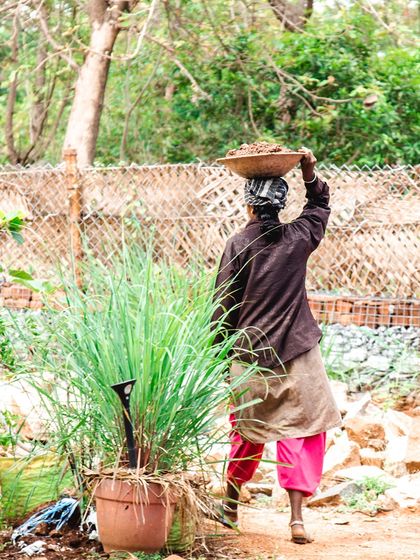 A woman mason carries earth at the Cheerville site. We believe in the women who make our drawings a reality, and their hard work makes us incredibly proud.