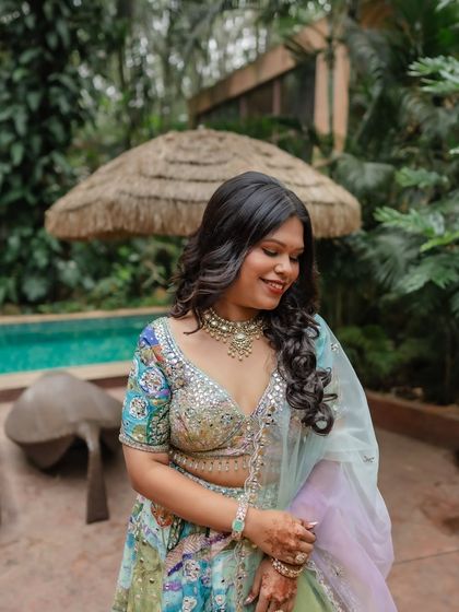 This client's Haldi or welcome event look was so vibrant. I gave her soft, glamorous waves and a dewy makeup look to match her colorful and modern lehenga.