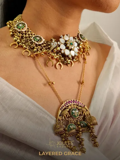 Layered grace in action. This unique combination features a delicate choker with crescent motifs and a longer temple-style pendant necklace, creating a look that is both traditional and artistically styled.