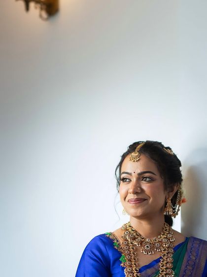 A candid moment of a smiling bride. The soft gold eyes and rosy nude lip create a fresh and radiant look that feels both traditional and modern.