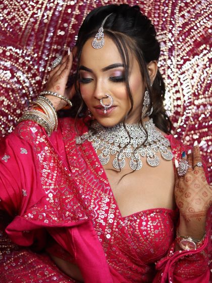 A full shot of the pink lehenga against a sequined backdrop, creating a glamorous party vibe.