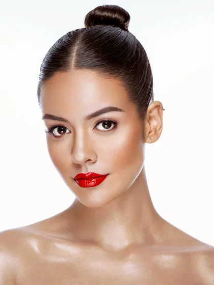 A classic beauty portrait with a bold red lip and clean, glowing skin. This timeless look is a must-have in any professional portfolio.