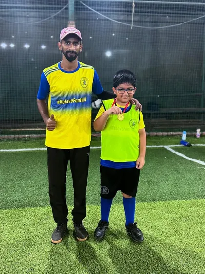 A coach celebrating with a Player of the Month. We are proud of our players' growth.