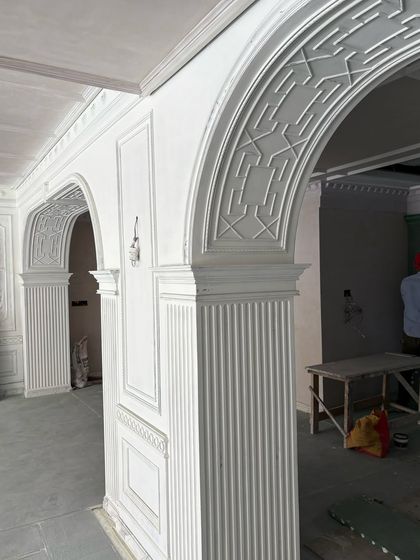 A wider view of the archways under construction. The repetition of these classical forms creates a sense of rhythm and harmony that will define the finished space.