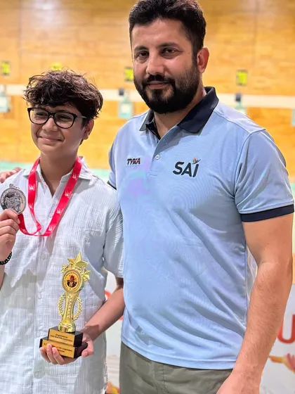 With a young silver medalist from the Delhi State Interschool Shooting Championship. I am proud to coach the next generation of shooting stars.