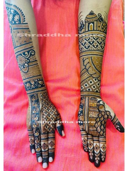 This design uses bold lines and geometric patterns to create a modern yet traditional look. The peacocks and architectural elements add a classic bridal touch.