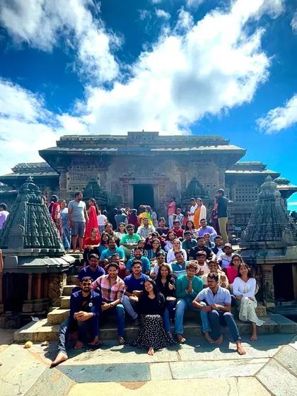A large group photo capturing the grandeur of the Hoysaleswara temple in Halebidu. These trips are perfect for history buffs and architecture lovers.