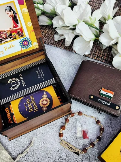 A classic Rakhi gift set in a premium wooden box. It includes a personalized wallet, a Rudraksha name rakhi, Denver perfume, and chocolate, with a custom photo on the box lid.