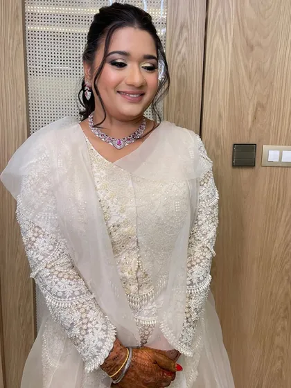 A celestial-themed sangeet or reception look. I created a textured, curly ponytail to go with her ethereal white outfit.