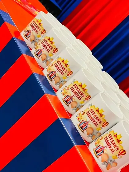 Personalized return gifts are a must. We created these custom-printed mugs with the carnival theme and the birthday boy's name, making for a thoughtful and memorable souvenir.