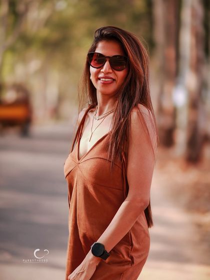 A relaxed and happy portrait on an open road. The warm tones and her bright smile create a feeling of warmth and positivity.