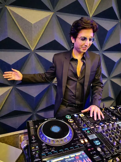 At the console, crafting the perfect musical journey for an incredible birthday party. A great event is all about the details, from the right track selection to reading the crowd's energy.