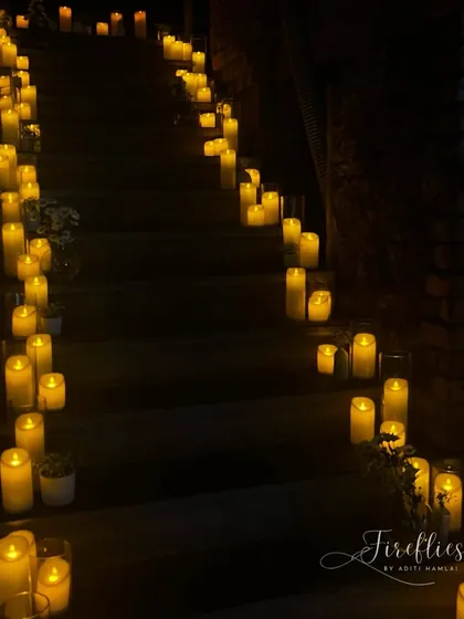 The stairway at the venue was transformed into a magical path, lined with dozens of glowing candles, creating a dramatic and romantic entrance for guests.