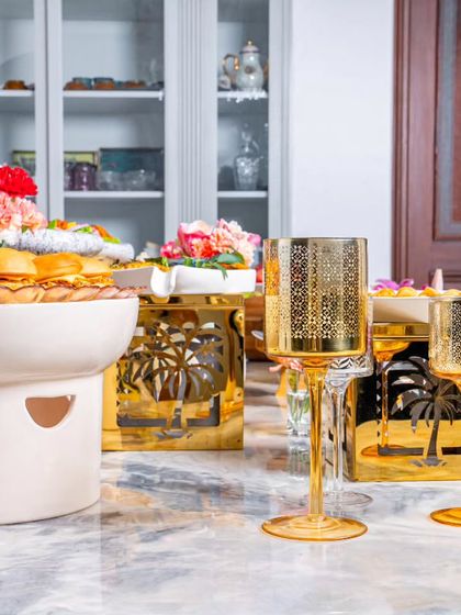 Style meets culinary excellence in our grazing table setups. Here, mini sliders are presented in a unique ceramic warmer.