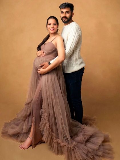 A stylish couple's portrait in our brown "Coco Breeze" ruffled gown, perfect for an earthy and warm-toned photoshoot.