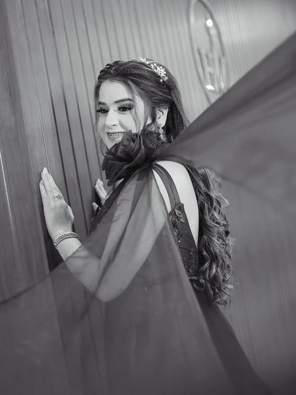 The same beautiful portrait in black and white. Removing the color emphasizes the form, texture, and movement of the gown, creating a timeless and artistic image.