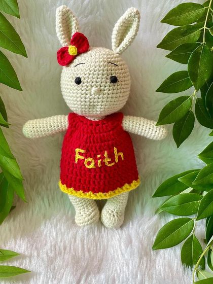This bunny in a bright red and yellow dress is personalized with the name "Faith". The vibrant colors make her so cheerful and fun.